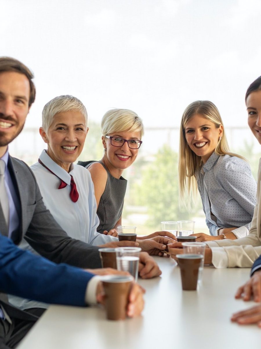portrait-of-successful-business-team-posing-in-office-e1615540244526.jpg